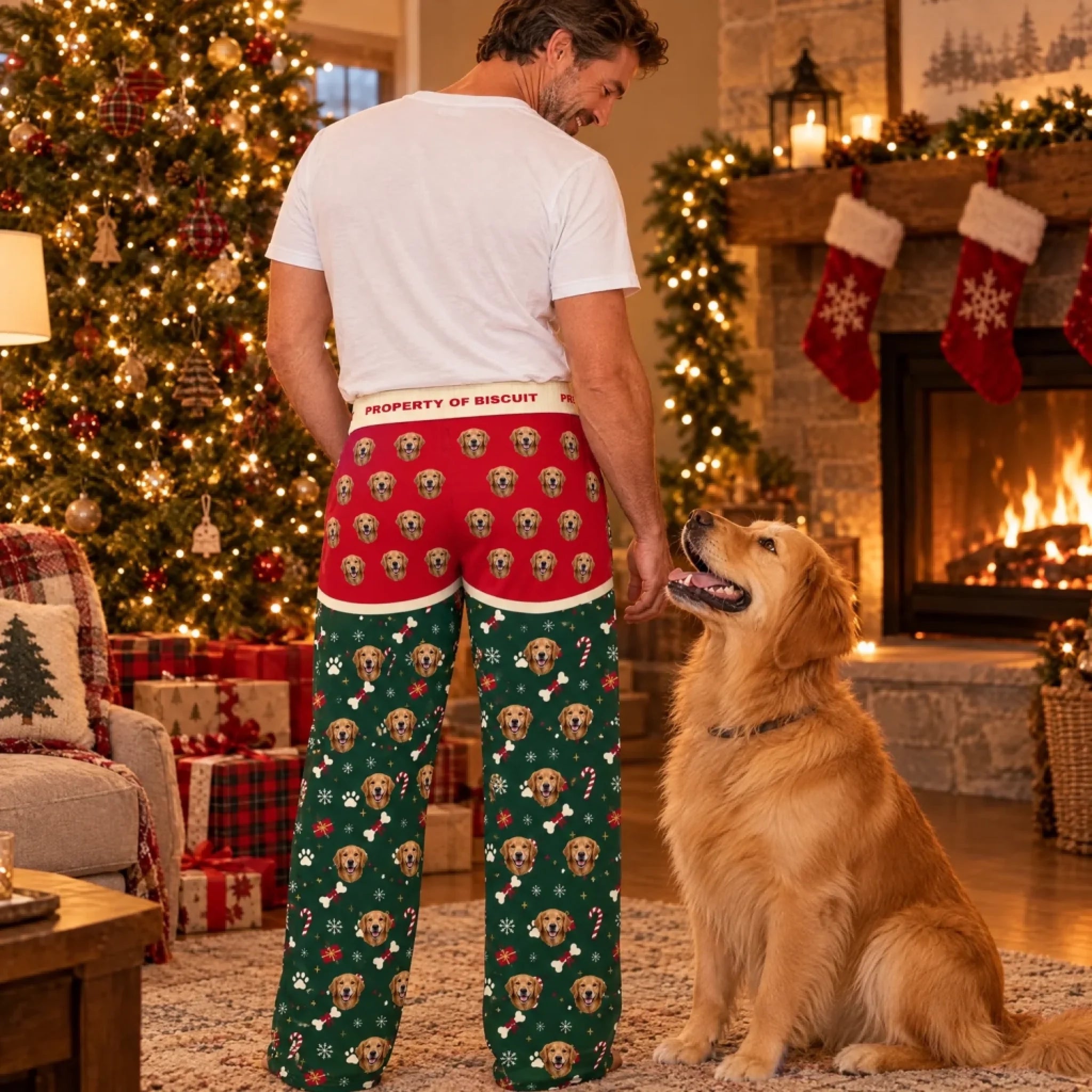 Man wearing personalized dog face Christmas pajama pants with his golden retriever